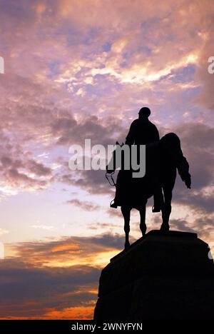 The General Meade Memorial is silhouetted against a sunset sky in Gettysburg National Military Park Stock Photo