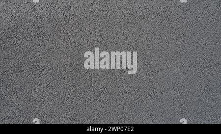 Gray background. Neatly plastered gray or black wall. Rough texture. Velvety effect. Professional finishing of walls, interiors, facades of buildings Stock Photo