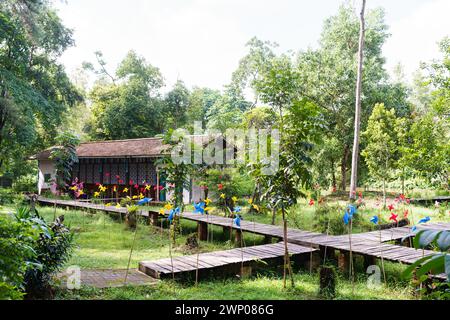 View of a Japanese-style house decorated with colorful paper windmills around the yard. Stock Photo