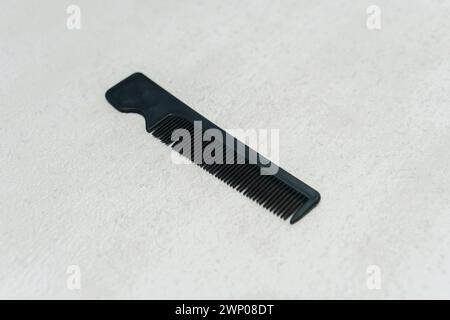 Simple small black plastic comb isolated on white background. Stock Photo