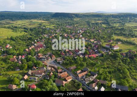 Flying over a village in Transylvania. Aerial drone view of Manastireni, Romania Stock Photo