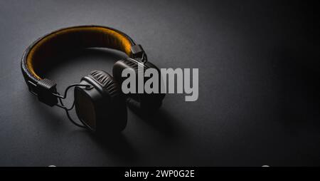 Retro style wireless over-ear headphones on dark gray background Stock Photo