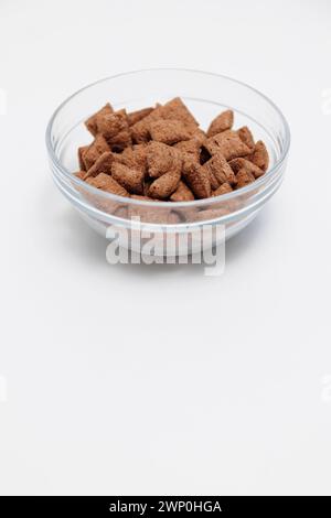 Sweet crispy corn pads in glass bowl on white with copyspace Stock Photo