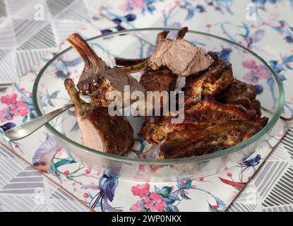 Baked, ready-to-eat saddle of lamb in a glass dish Stock Photo