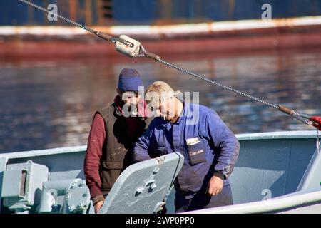 Vigo,Pontevedra, Spain; October,22,2021; Metal workers fixing a ship with their cigarette in their mouth and stained with grease Stock Photo