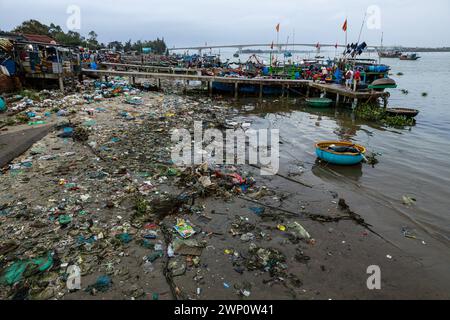 The dirty beach of the fishing harbor of Hoi An in Vietnam Stock Photo