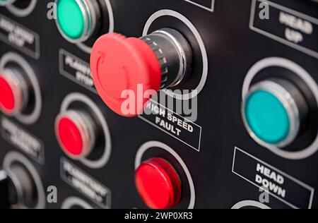 Black control panel with red and green round lamps and buttons. Abstract industrial background. Stock Photo