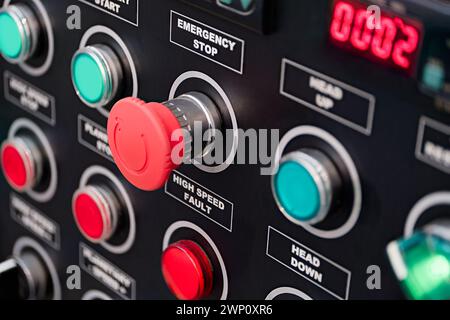 Black control panel with red and green round lamps and buttons. Abstract industrial background. Stock Photo