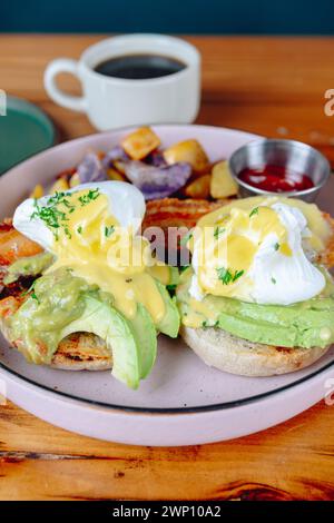 A plate of food with two sandwiches and a cup of coffee. The sandwiches are topped with avocado and mayonnaise, and the coffee is served in a white cu Stock Photo