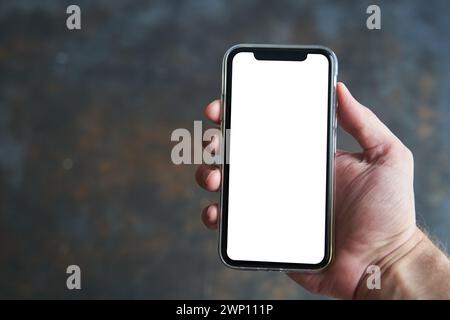 Kaliningrad, Russia - 08.08.2020: A man holds in his hand a smartphone. Mockup Stock Photo