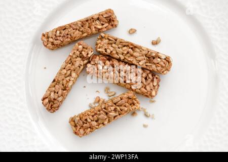 Plate with tasty pieces of kozinaki and sunflower seeds. Top view Stock Photo