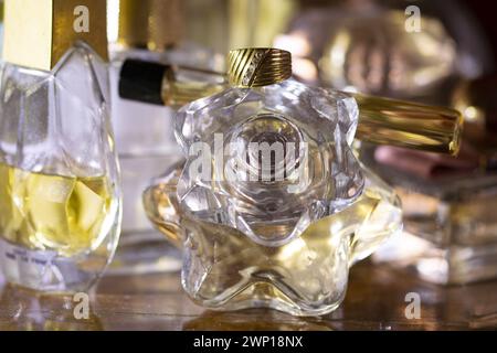 old family ring with diamonds placed on a perfume bottle Stock Photo