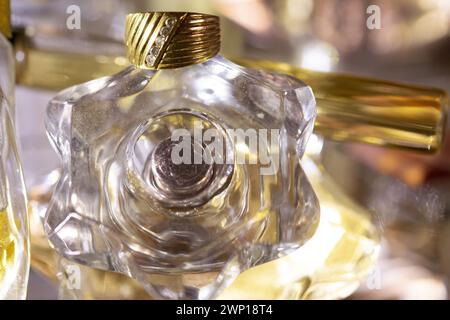 old family ring with diamonds placed on a perfume bottle Stock Photo