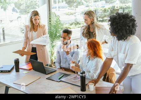 Multiracial coworkers discussing new projects and planning strategies while working together. Business concept. Stock Photo