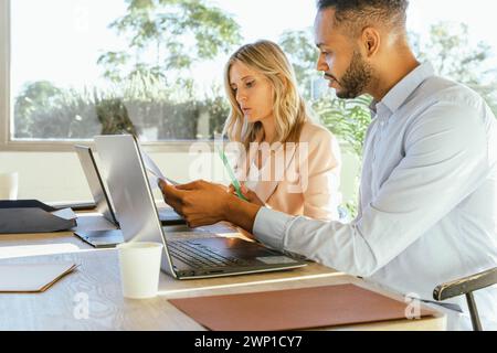 Business colleagues analyzing paperwork while working together in the office. Business concept. Stock Photo
