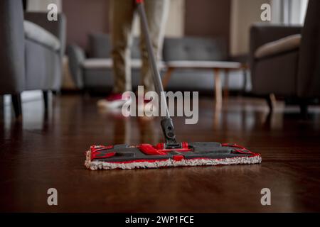 Woman Mops Floor With Mop In Room, Close Up Stock Photo