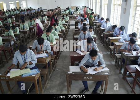 Students are seen writing an English paper. This is the first exam for the higher secondary (Class 12) board exam organized by TBSE (Tripura Board of Secondary Education) in Agartala. Tripura, India. Stock Photo