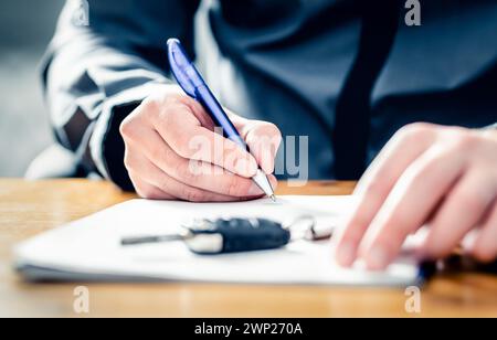 Car lease loan document. Auto finance or insurance paperwork. Sell, rent or buy used vehicle. Dealership company or rental agency contract policy. Stock Photo