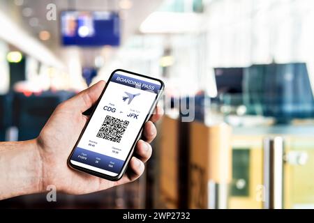 Boarding pass in phone at airport. Electronic flight ticket. Digital mobile app with QR code. Airplane travel with modern airline. Stock Photo
