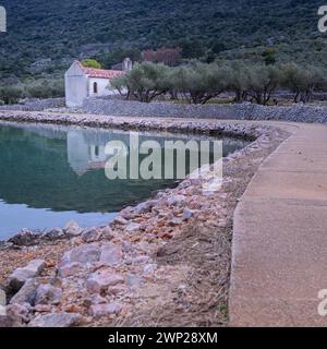 Path, small chapel and calm sea near Cres Croatia after sunset in springtime Cres Croatia Stock Photo