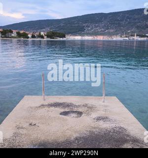 Calm sea near Cres Croatia after sunset in springtime, concrete platform Cres Croatia Stock Photo
