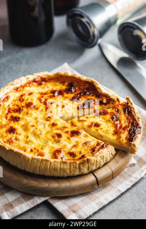 Traditional french pie. Quiche lorraine on the kitchen table. Stock Photo