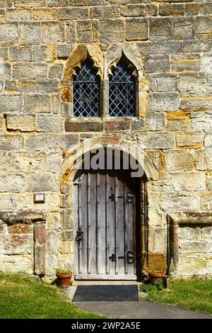 Detail of round arched door and windows of belfry of St Thomas a Becket church in summer, Capel, Kent, England Stock Photo