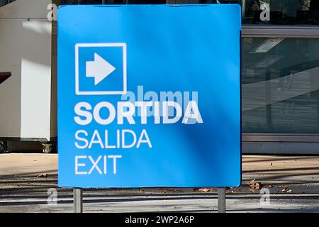 Trilingual exit sign in Spanish (Salida), Catalan (Sortida) and English (Exit), highlighting the multilingual approach to safety and direction in a pu Stock Photo