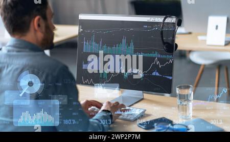 Focused man analyzing complex financial statistics on a computer monitor Stock Photo