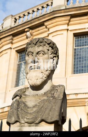 UK, Oxford, Emperor Heads, Stonework on Wren's Sheldonian Theatre. Stock Photo