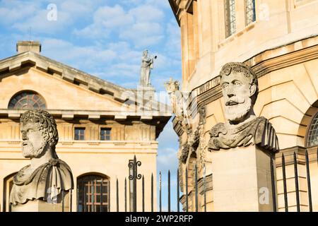 UK, Oxford, Emperor Heads, Stonework on Wren's Sheldonian Theatre. Stock Photo