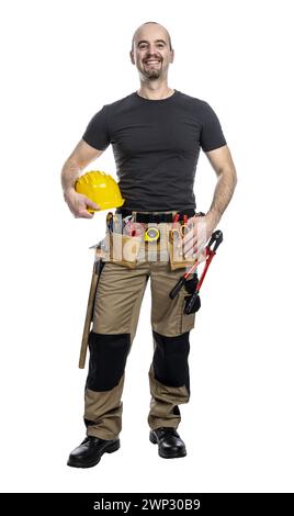 Cheerful male construction worker in casual attire holding a yellow hard hat Stock Photo