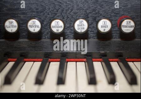 Stop knobs and manual of a pump organ Stock Photo