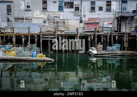 A view of Custom House Wharf, a section of Portland Maine's working waterfront. Lobster pots are seen in the foreground. Portland, Maine, USA. Stock Photo