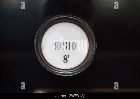 Stop knob of a pump organ labelled Echo Stock Photo