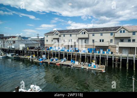 A view of Custom House Wharf, a section of Portland Maine's working waterfront. Lobster pots are seen in the foreground. Portland, Maine, USA. Stock Photo