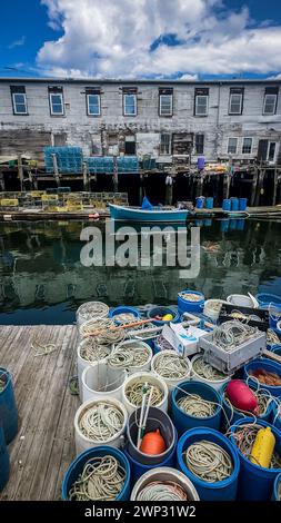 A view of Custom House Wharf, a section of Portland Maine's working waterfront. Lobster pots are seen in the foreground. Portland, Maine, USA. Stock Photo