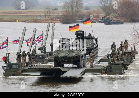 Korzeniewo, Pomorskie, Poland on March 5, 2024. German and British servicemen present transfer of tanks and armored vehicles via Vistula river during NATO's Dragon-24 exercise, a part of large scale Steadfast Defender-24 exercise. The exercises, which take place mainly in Central Europe, involve some 90,000 troops from all NATO countries as well as Sweden. The aim of Steadfast Defender-24 is to deter and present defensive abilities in the face of aggression. Credit: Dominika Zarzycka/Alamy Live News Stock Photo
