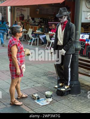 A Michael Jackson impersonator performs for a tourist in the Colonial City of Santo Domingo, Dominican Republic.  UNESCO World Heritage Site of the Co Stock Photo