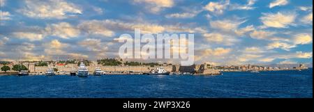 Panoramic view of the medieval town of Rhodes and its harbour from the sea, with his famous historic landmarks: De Naillac Tower, Rhodes Windmills, Sa Stock Photo