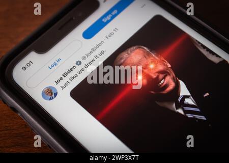 A post “Just Like We Drew It Up.” with iconic Joe Biden with red glowing eyes picture on X app (formerly Twitter), seen in an iPhone Stock Photo