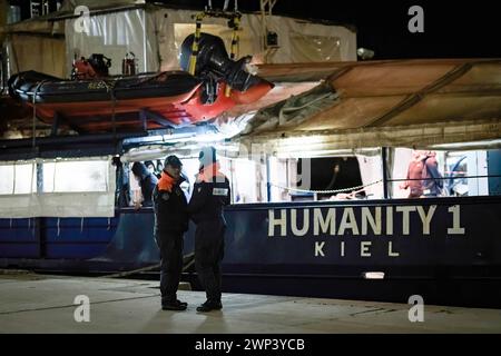 Crotone, Italy. 04th Mar, 2024. Italian Coast Guard seen in front of the rescue vessel. The rescue ship Humanity 1 of the German NGO SOS Humanity arrived in the port of Crotone with 77 migrants, mainly from Bangladesh and Pakistan, rescued from three fiberglass boats in international waters, on Saturday 2 March 2024. Reportedly, during the rescue operations, the crew and the people were threatened by the Libyan Coast Guard. (Photo by Valeria Ferraro/SOPA Images/Sipa USA) Credit: Sipa USA/Alamy Live News Stock Photo