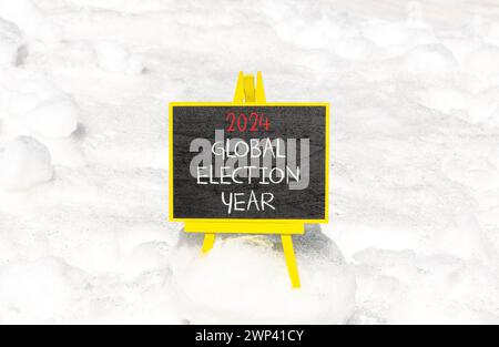 2024 global election year symbol. Concept words 2024 global election year on beautiful black chalk blackboard. Beautiful white snow background. Busine Stock Photo