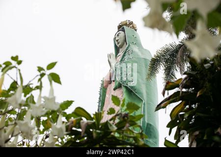 Huatusco, Veracruz, Mexico - July 13, 2022: Monsoon rain falls on the famous gigantic statue dedicated to the Virgen de Guadalupe. Stock Photo