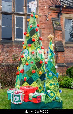 Knitted or crocheted Christmas Tree with presents, on display at the Ruddington Christmas Market, Nottinghamshire, England, UK Stock Photo