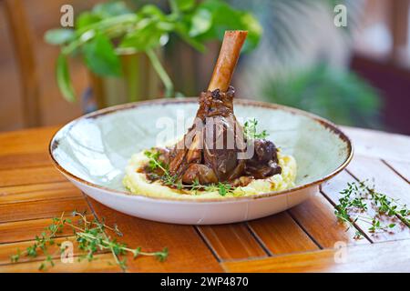 Braised lamb shank on the mashed potato in the restaurant Stock Photo