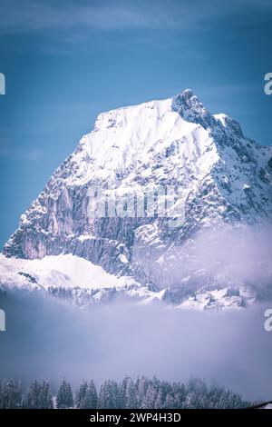 Prominent snowy mountain peak against a clear blue sky, Kaisergebierge, The Mountain Doctor, Elmau, Austria Stock Photo