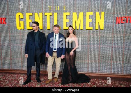 Theo James, Guy Ritchie and Kaya Scodelario attending the premiere of Netflix series The Gentlemen at the Theatre Royal Drury Lane, London. Picture date: Tuesday March 5, 2024. Stock Photo