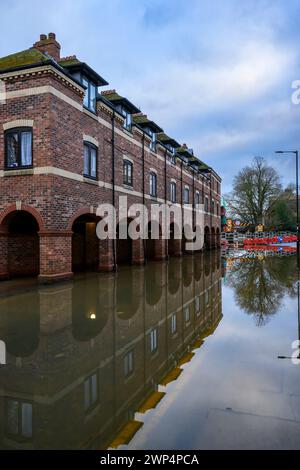 River Ouse burst its banks after heavy rain (riverside route under high flood water, flats overlooking roadway) - York, North Yorkshire, England UK. Stock Photo