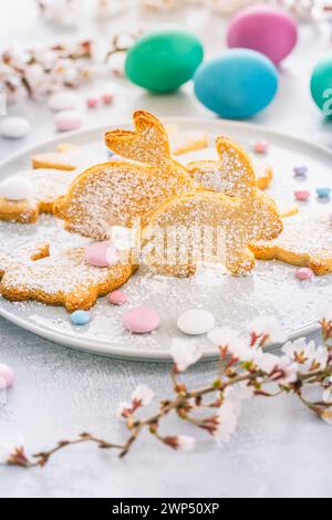 Homemade almond bunny cookies for Easter with colorful Easter eggs Stock Photo